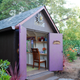 A backyard she shed with a home office inside.